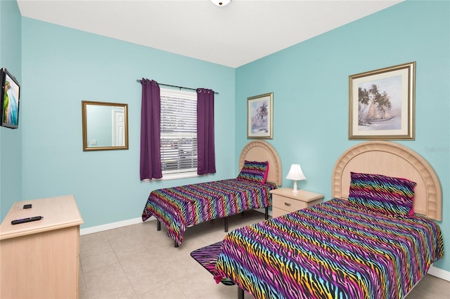 bedroom with tile patterned floors and baseboards