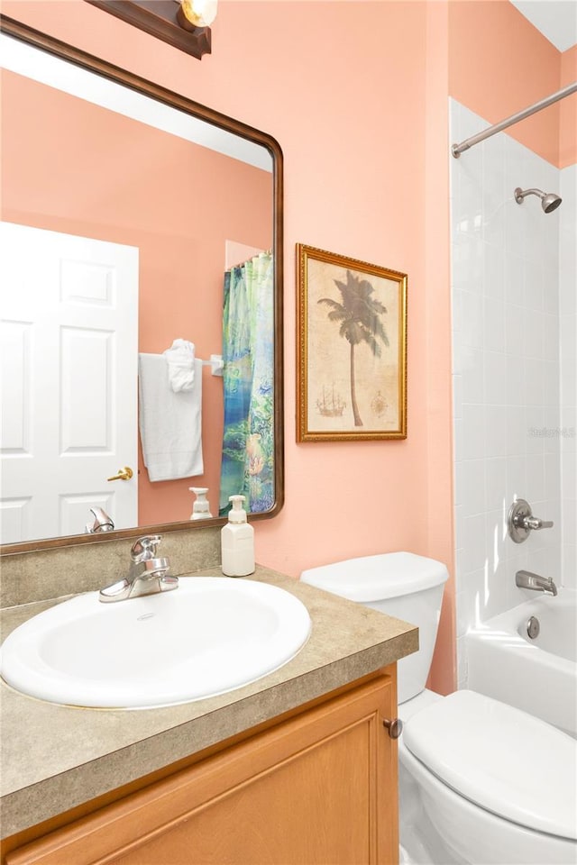 bathroom with toilet,  shower combination, and vanity