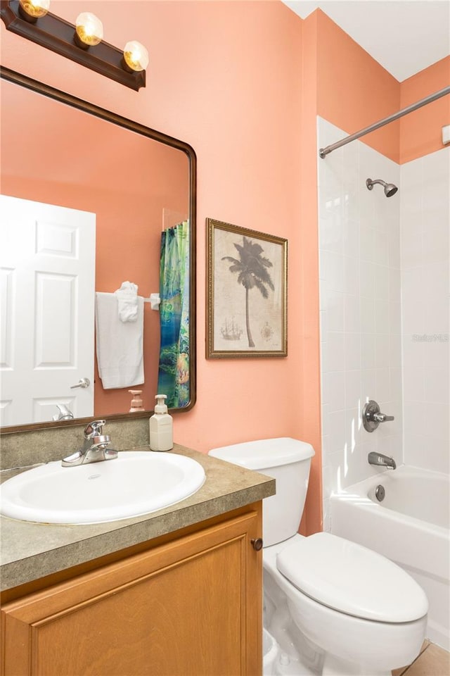 bathroom with toilet, vanity, and bathing tub / shower combination