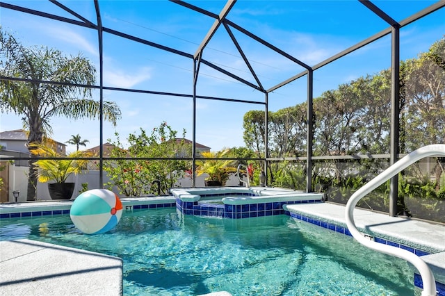 view of pool featuring a lanai, a pool with connected hot tub, and a patio