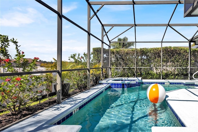 view of pool featuring a patio, a lanai, and a pool with connected hot tub