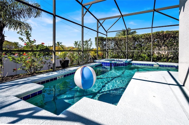 view of swimming pool with a lanai, a pool with connected hot tub, and a patio