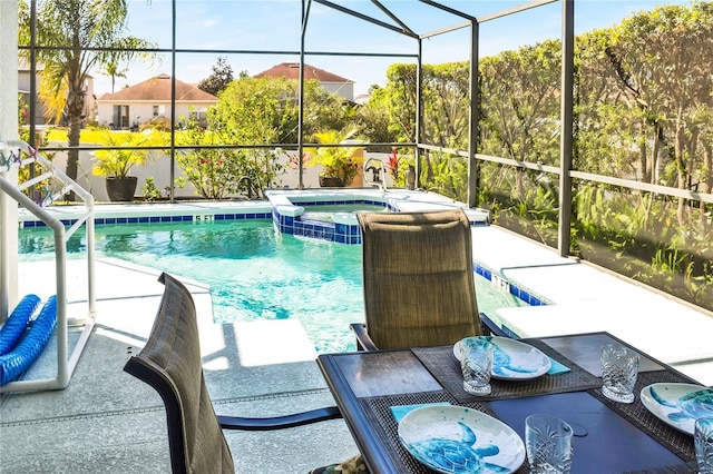 view of pool featuring a pool with connected hot tub, a lanai, and a patio area