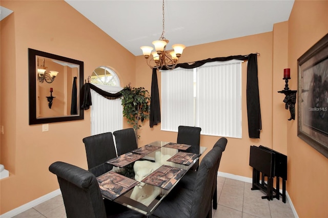 dining space with tile patterned floors, baseboards, lofted ceiling, and an inviting chandelier