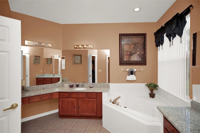 full bathroom featuring tile patterned flooring, a bath, and vanity