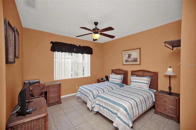 bedroom featuring light tile patterned floors, visible vents, baseboards, and a ceiling fan