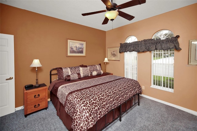 carpeted bedroom with baseboards and ceiling fan