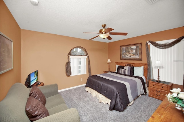 bedroom featuring carpet flooring, a ceiling fan, baseboards, and a textured ceiling