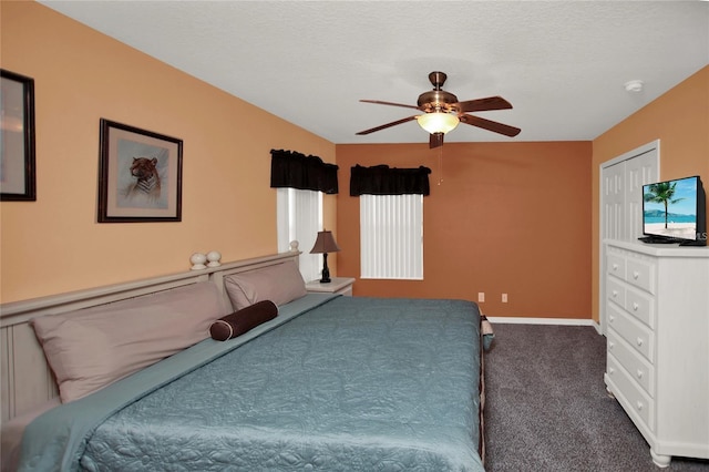 carpeted bedroom with a ceiling fan, baseboards, and a textured ceiling