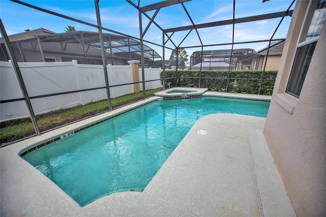 view of pool with glass enclosure, a pool with connected hot tub, and a patio