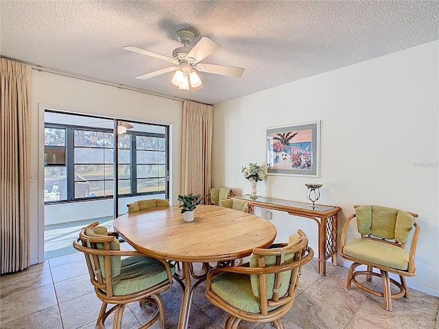 dining area with a textured ceiling and ceiling fan