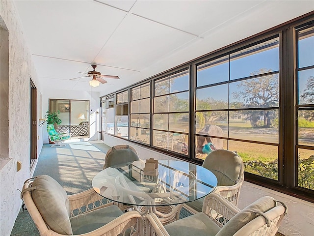 sunroom with a wealth of natural light and ceiling fan