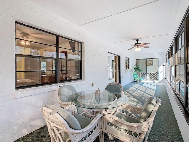 sunroom / solarium featuring ceiling fan