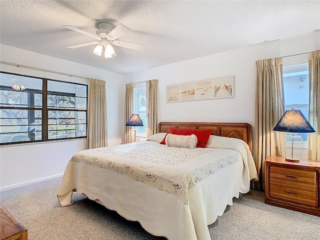 bedroom with baseboards, a textured ceiling, and a ceiling fan