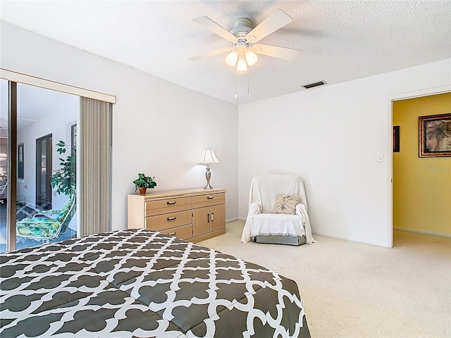 bedroom with a ceiling fan, visible vents, access to exterior, a textured ceiling, and light colored carpet