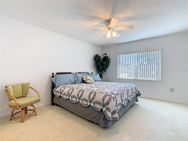 carpeted bedroom with baseboards, a textured ceiling, and ceiling fan