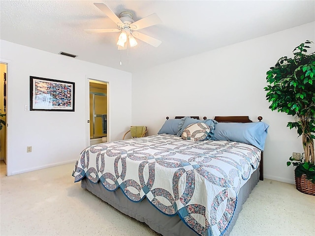 bedroom featuring visible vents, baseboards, a textured ceiling, and ceiling fan