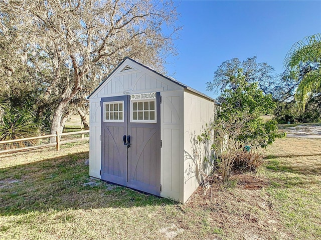 view of shed featuring fence