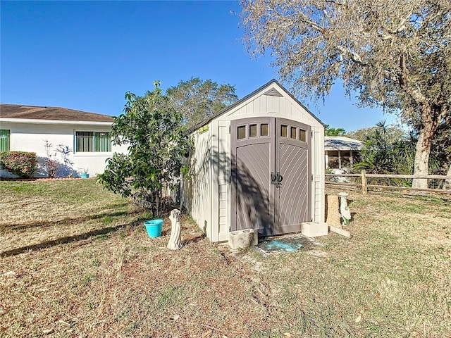 view of shed with fence