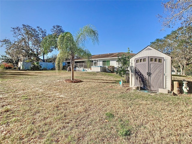 view of yard with an outbuilding and a shed