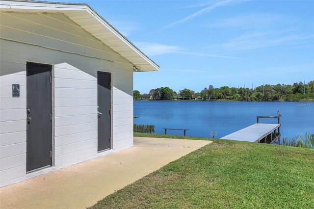 dock area featuring a water view and a lawn