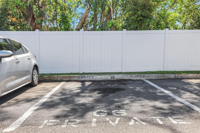 uncovered parking lot featuring fence