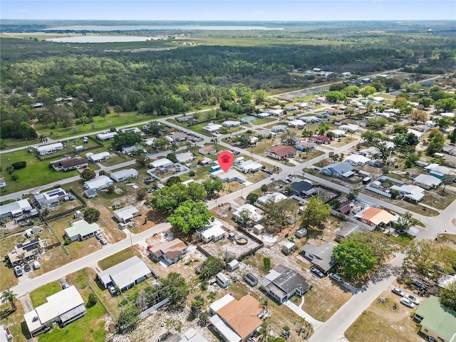 drone / aerial view with a forest view and a residential view