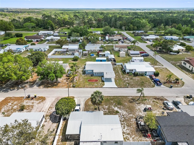 bird's eye view with a wooded view