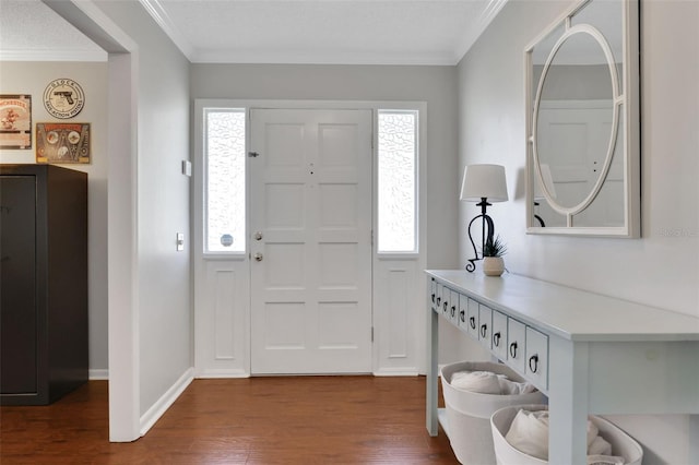 foyer entrance with dark wood finished floors, crown molding, and baseboards