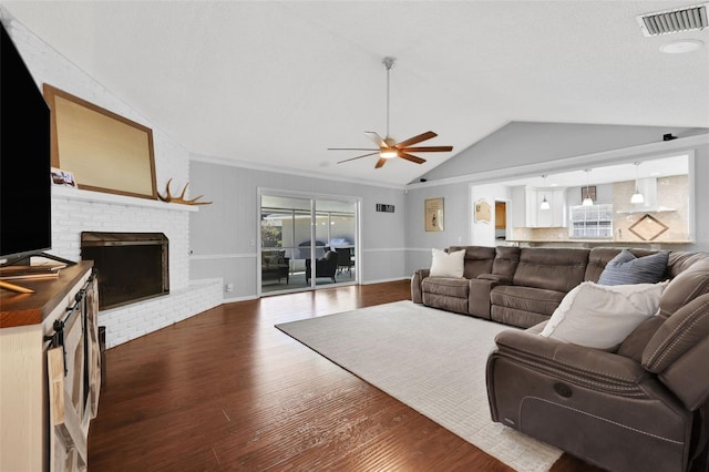 living area with visible vents, a healthy amount of sunlight, ceiling fan, dark wood finished floors, and lofted ceiling