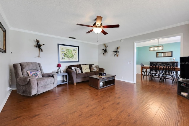 living area with visible vents, ornamental molding, and dark wood-style flooring