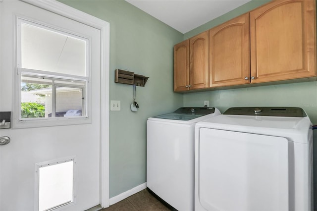 laundry room with baseboards, cabinet space, dark tile patterned flooring, and independent washer and dryer