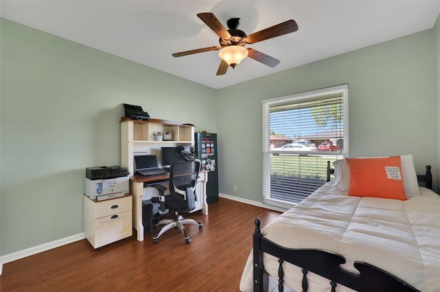 bedroom featuring dark wood finished floors, a ceiling fan, and baseboards