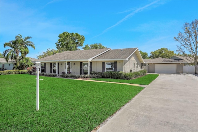 single story home featuring brick siding, an attached garage, concrete driveway, and a front lawn