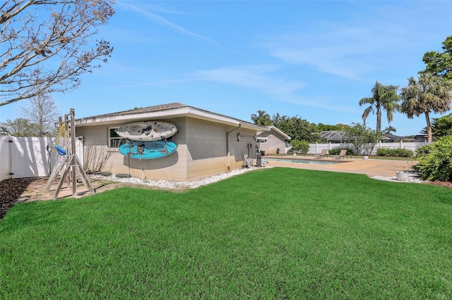 view of yard featuring a patio, a fenced in pool, and fence