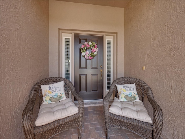 entrance to property featuring stucco siding