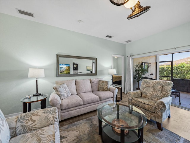 living room with wood finished floors and visible vents
