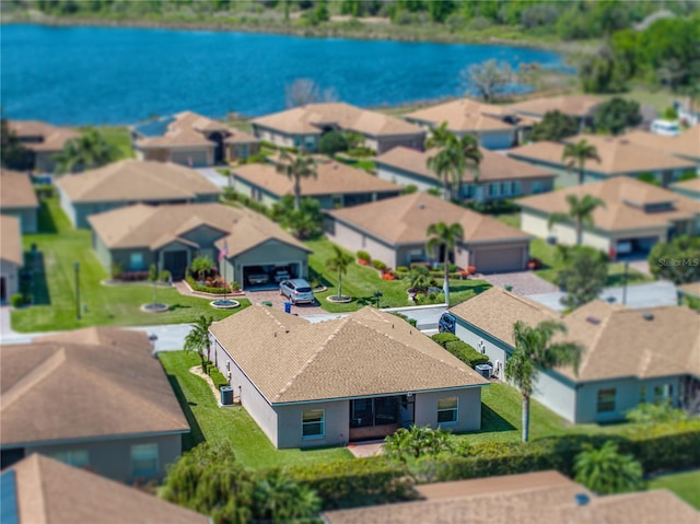 bird's eye view with a residential view and a water view
