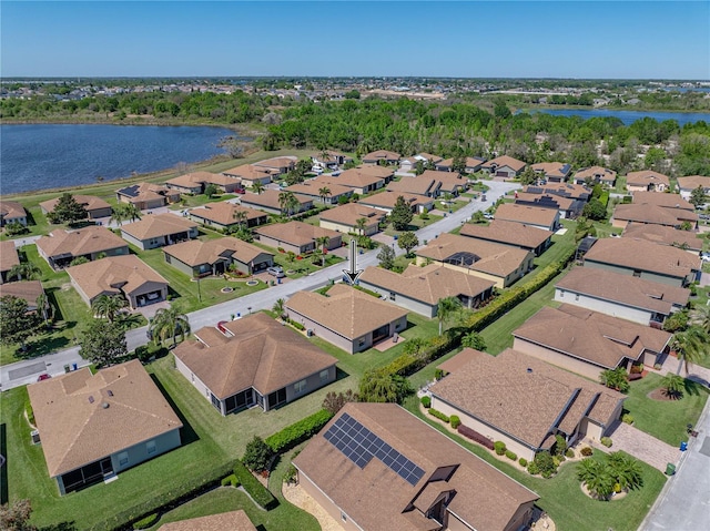 birds eye view of property featuring a water view and a residential view