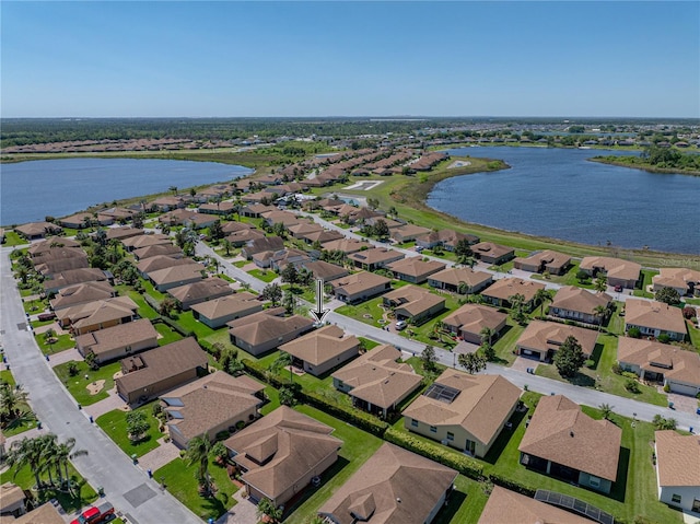bird's eye view featuring a water view and a residential view