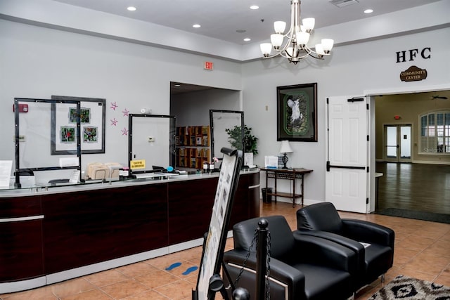 welcome area with visible vents and a chandelier