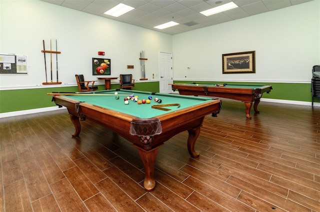 rec room with a paneled ceiling, billiards, and wood finished floors