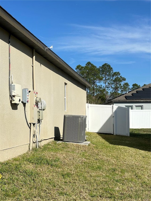 view of yard with cooling unit and fence