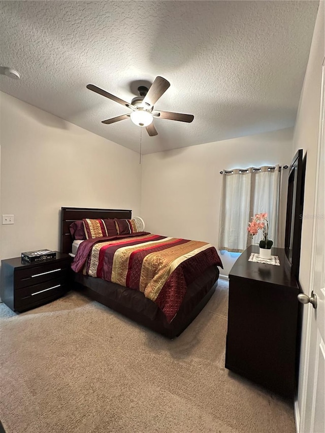 carpeted bedroom with a textured ceiling and ceiling fan