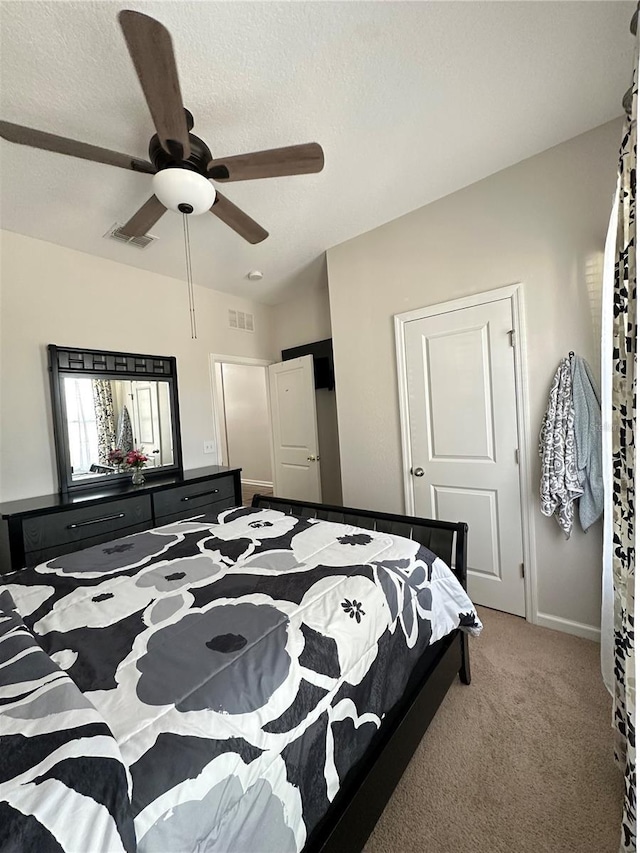 bedroom with visible vents, carpet flooring, a textured ceiling, and vaulted ceiling