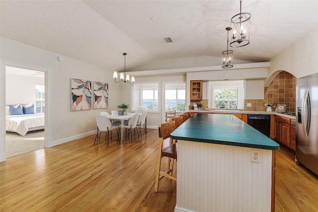 819 Seminole Rd, Babson Park, FL 33827 - kitchen featuring dishwasher, light wood-type flooring, vaulted ceiling, an inviting chandelier, and stainless steel refrigerator with ice dispenser
