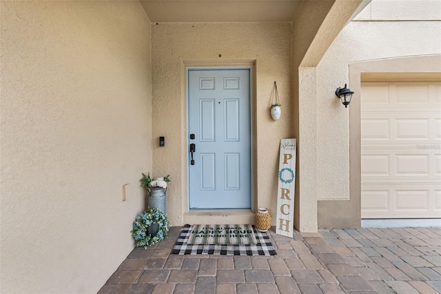 entrance to property with stucco siding