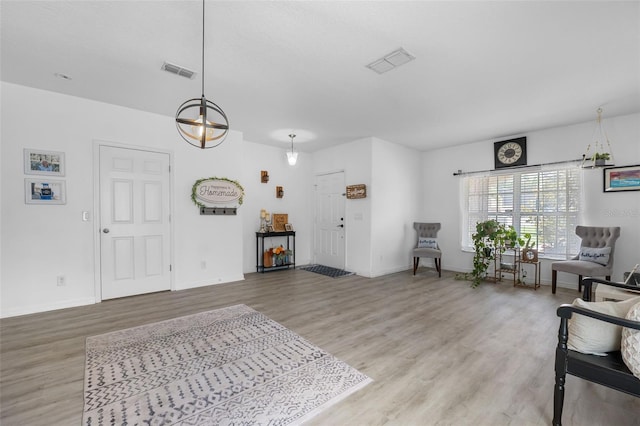 foyer with visible vents, baseboards, and wood finished floors