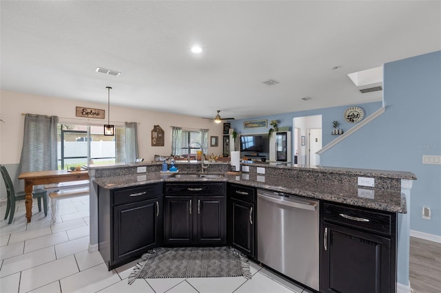 kitchen with a wealth of natural light, visible vents, a sink, stainless steel dishwasher, and dark cabinetry