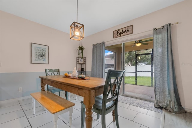 dining space featuring light tile patterned flooring, baseboards, and ceiling fan